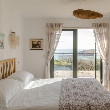 Master bedroom with far reaching views out to sea and over looking Trewent Headland