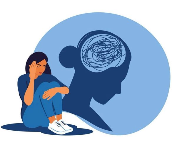 A woman sits in emotional discomfort, symbolizing mental strain and the impact of stress.