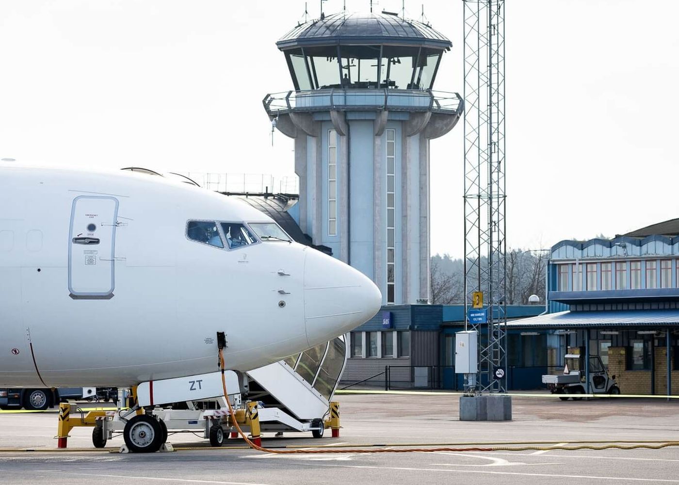 Flygplansnos vid terminalbyggnad och flygledartorn på Norrköpings flygplats