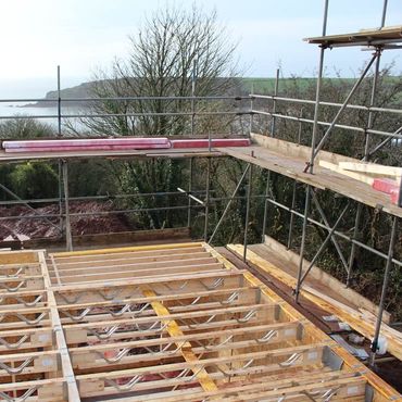 view from first floor going up looking out to sea with scaffolding in place ready for second floor to go up