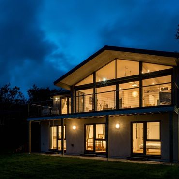 View of Green Shutters taken from outside in the garden at night