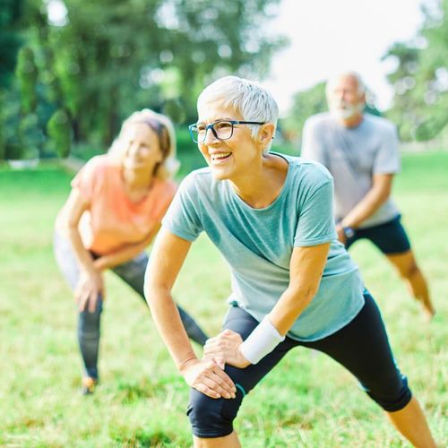 Three persons exercising outdoors