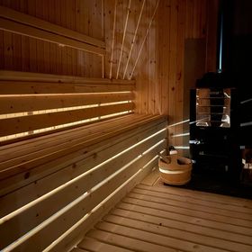 view of the inside of our mobile wood fired sauna at night with lights on