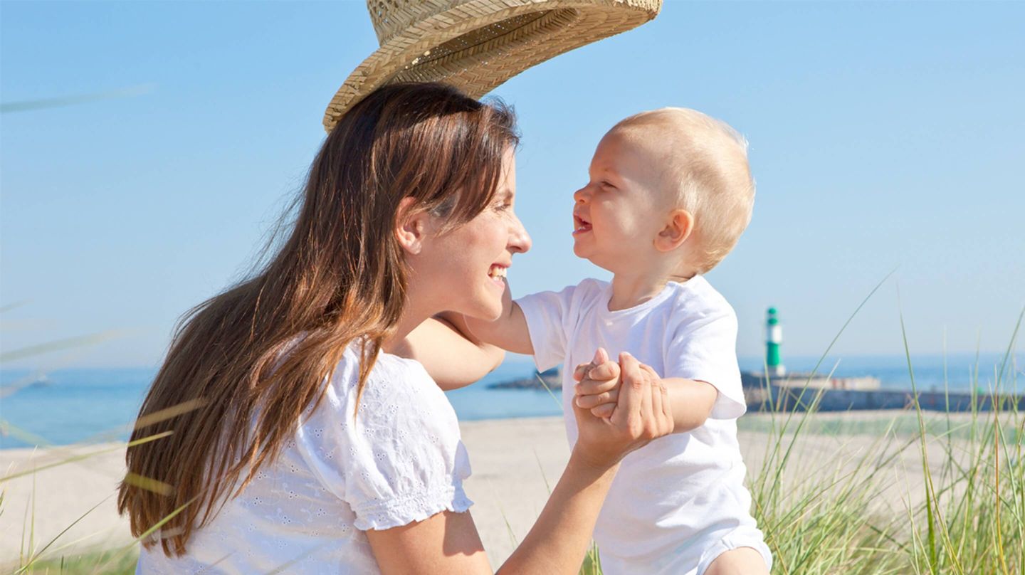 Mother and baby on the beach