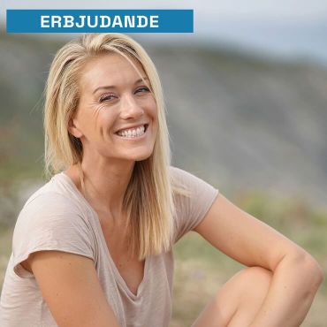 Woman sitting on nature smiling