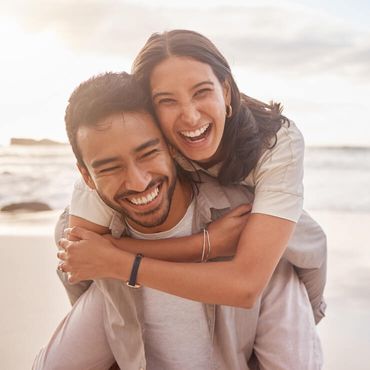 Couple laughing at the beach