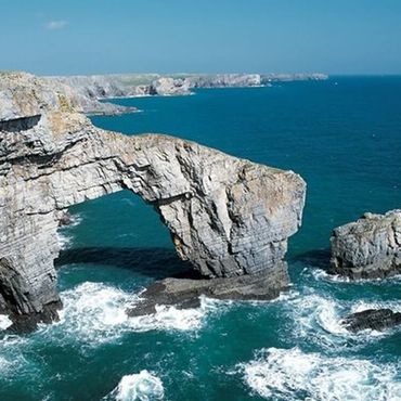 The Green Bridge of Wales is a natural arch formed from Carboniferous Limestone within the Pembrokeshire Coast National Park in Pembrokeshire, Wales. It is located in the Castlemartin Training Area