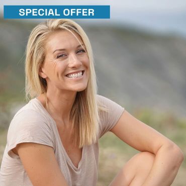 Woman sitting on nature smiling